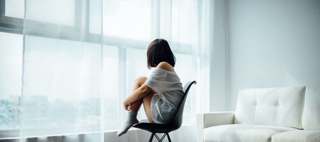 depressed woman by window