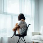 depressed woman by window